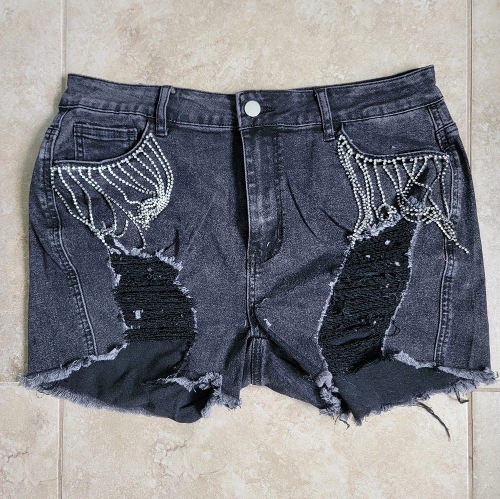 Black shorts with rips and rhinestone fringe